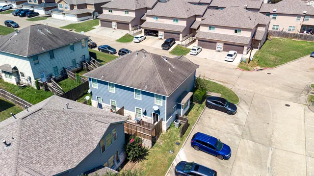 an aerial view of residential houses with outdoor space