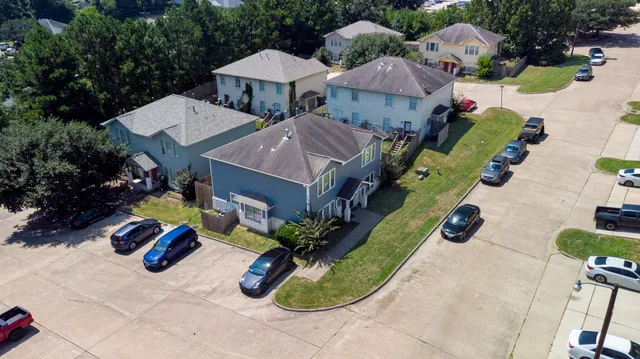 an aerial view of a house with garden space and street view