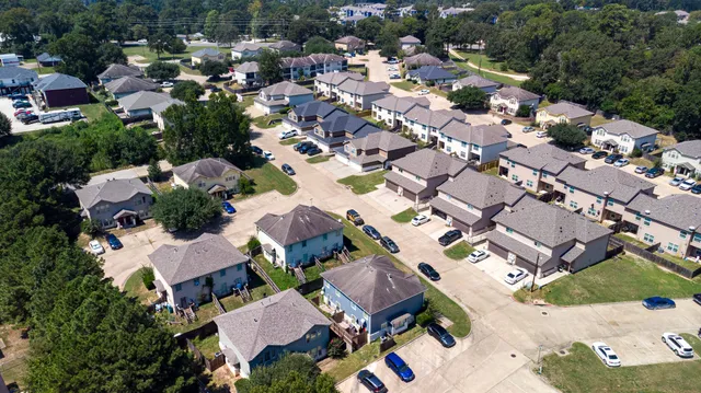 an aerial view of residential houses with outdoor space