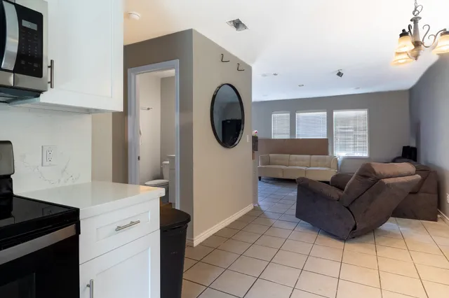 a living room with furniture a mirror a washer and dryer