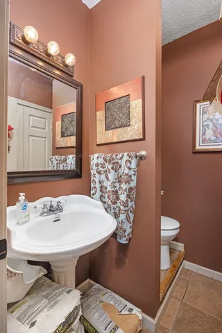 a bathroom with a sink a mirror and a toilet