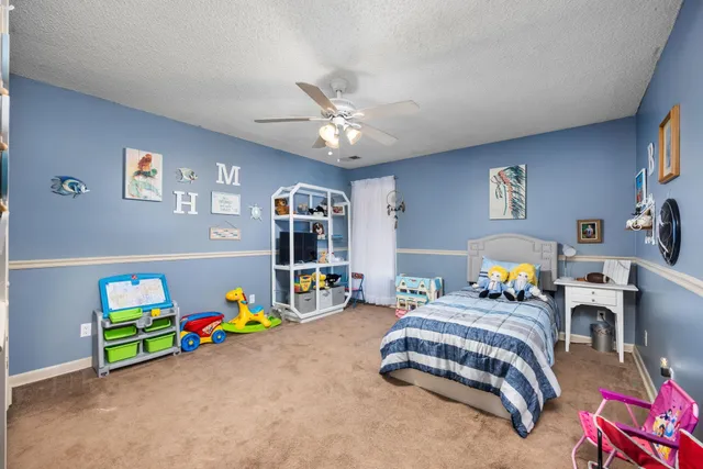 a bedroom with bed and window