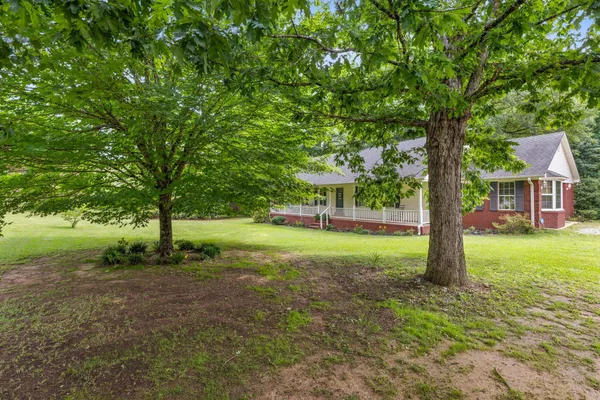 a view of a house with backyard and sitting area
