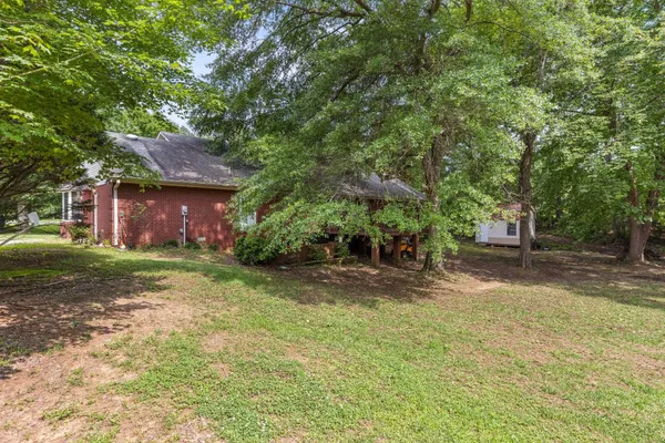 a view of a house with a yard and sitting area