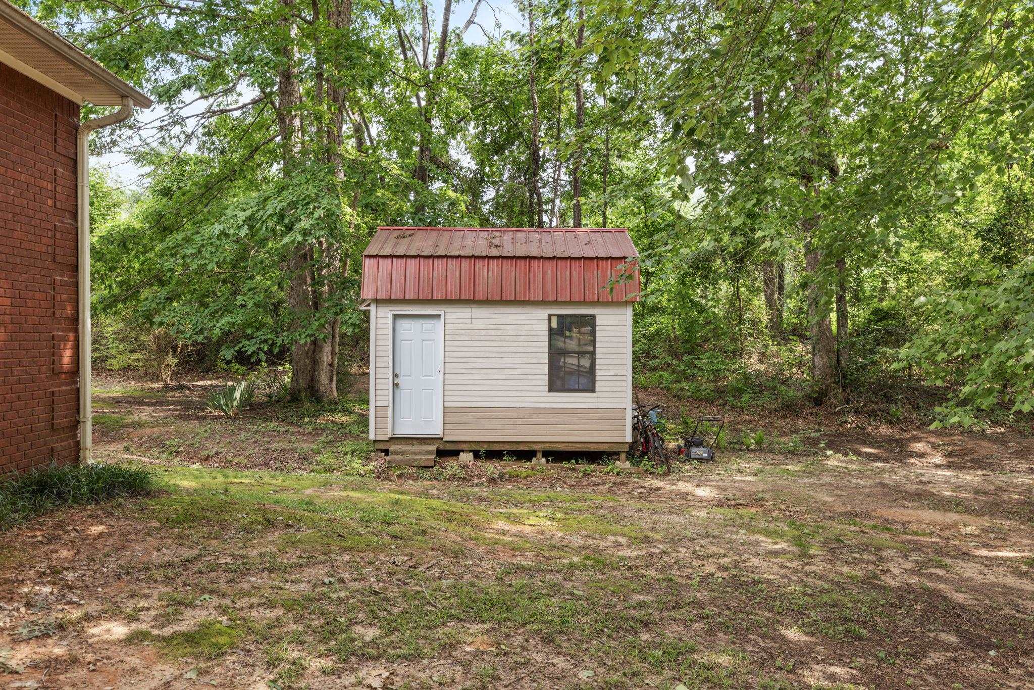 4625 Tucker Road Golden, MS 38847 - Photo 10 of 35 a view of a barn in the yard with large trees