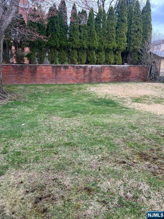 24 Stony Hill Road Clifton, NJ 07013 - Photo 16 of 17 a view of yard with swimming pool and trees in the background