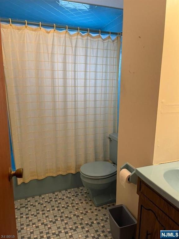 24 Stony Hill Road Clifton, NJ 07013 - Photo 8 of 17 a bathroom with a toilet and a shower curtain