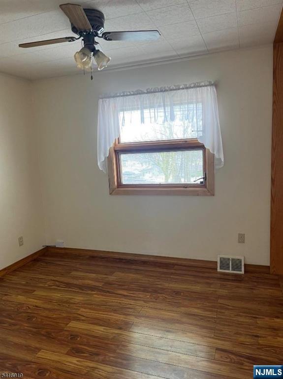 24 Stony Hill Road Clifton, NJ 07013 - Photo 10 of 17 a view of a room with wooden floor and chandelier
