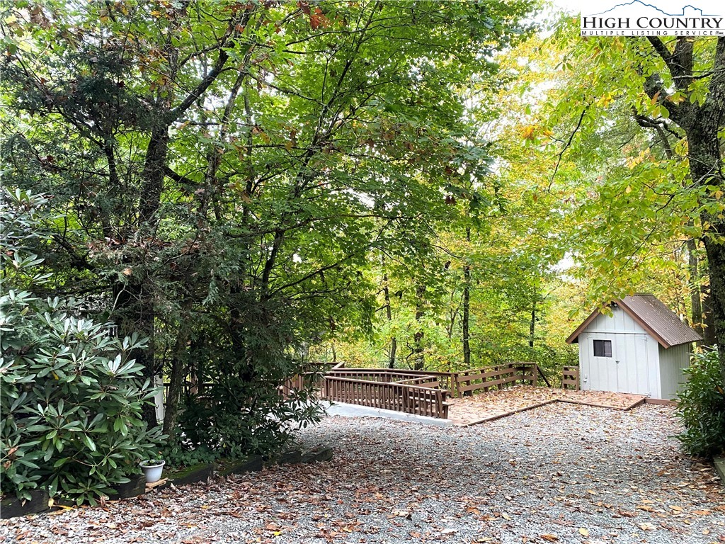 33 Goldfinch Road Newland, NC 28657 - Photo 26 of 29 a view of backyard with large trees and plants