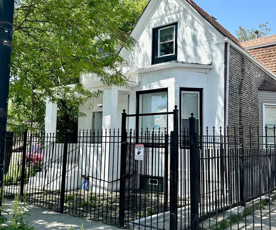 a view of a house with a iron gate