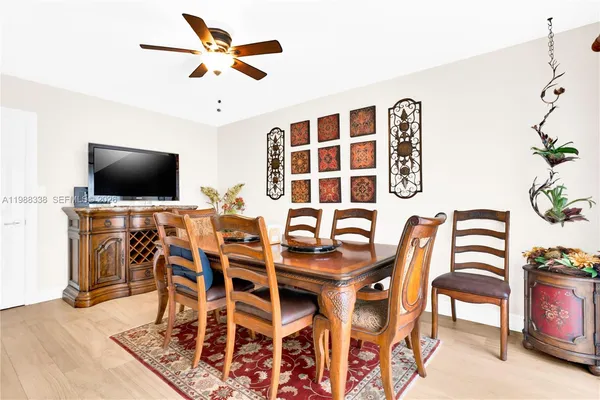 a view of a dining room with furniture and wooden floor