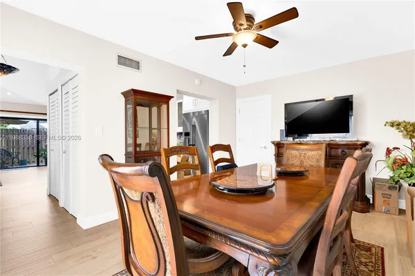 a view of a dining room with furniture and wooden floor