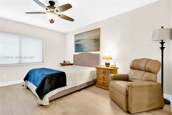 a living room with a couch and a ceiling fan
