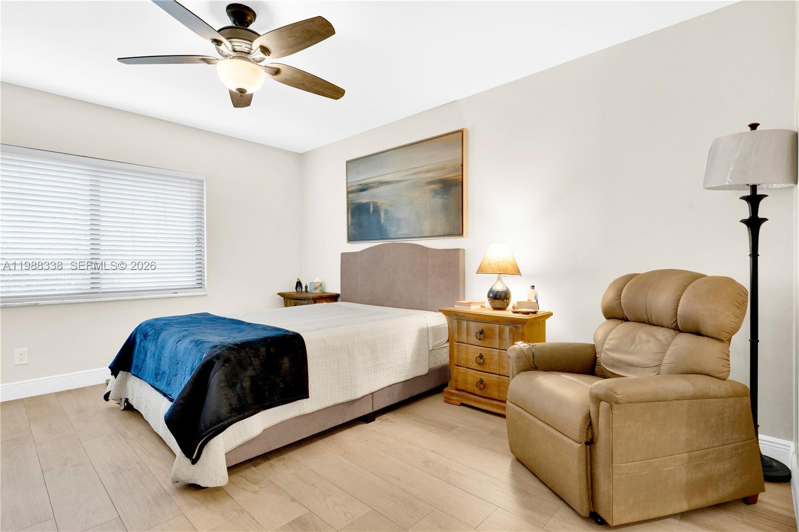 10909 Southwest 113th Place, Unit 68A Miami, FL 33176 - Photo 17 of 37 a living room with a couch and a ceiling fan