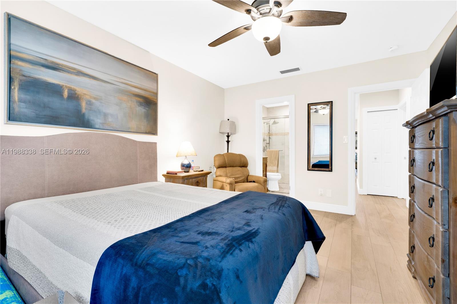 10909 Southwest 113th Place, Unit 68A Miami, FL 33176 - Photo 18 of 37 a bedroom with a large bed and a chandelier