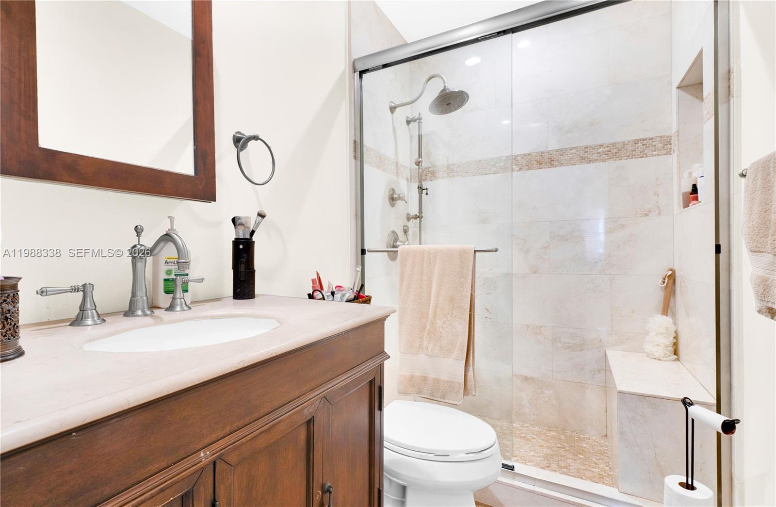 10909 Southwest 113th Place, Unit 68A Miami, FL 33176 - Photo 20 of 37 a bathroom with a sink a toilet and a mirror