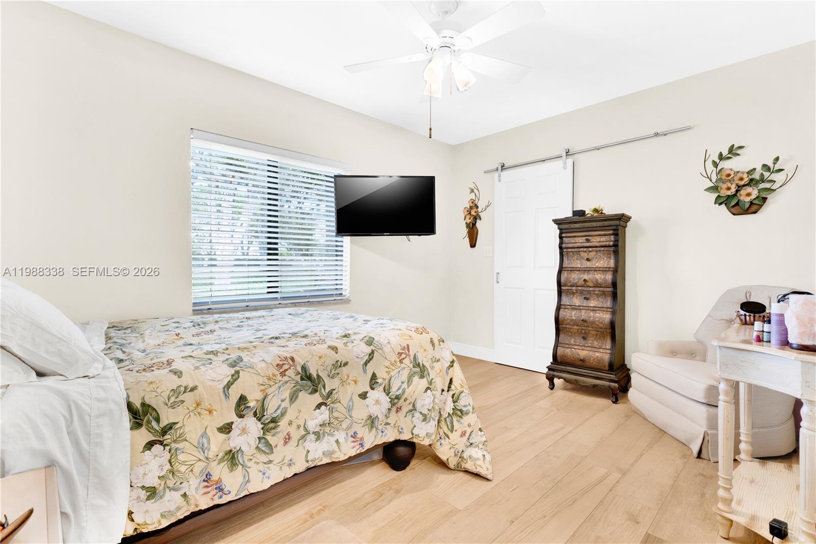 10909 Southwest 113th Place, Unit 68A Miami, FL 33176 - Photo 21 of 37 a bedroom with a bed and a flat screen tv