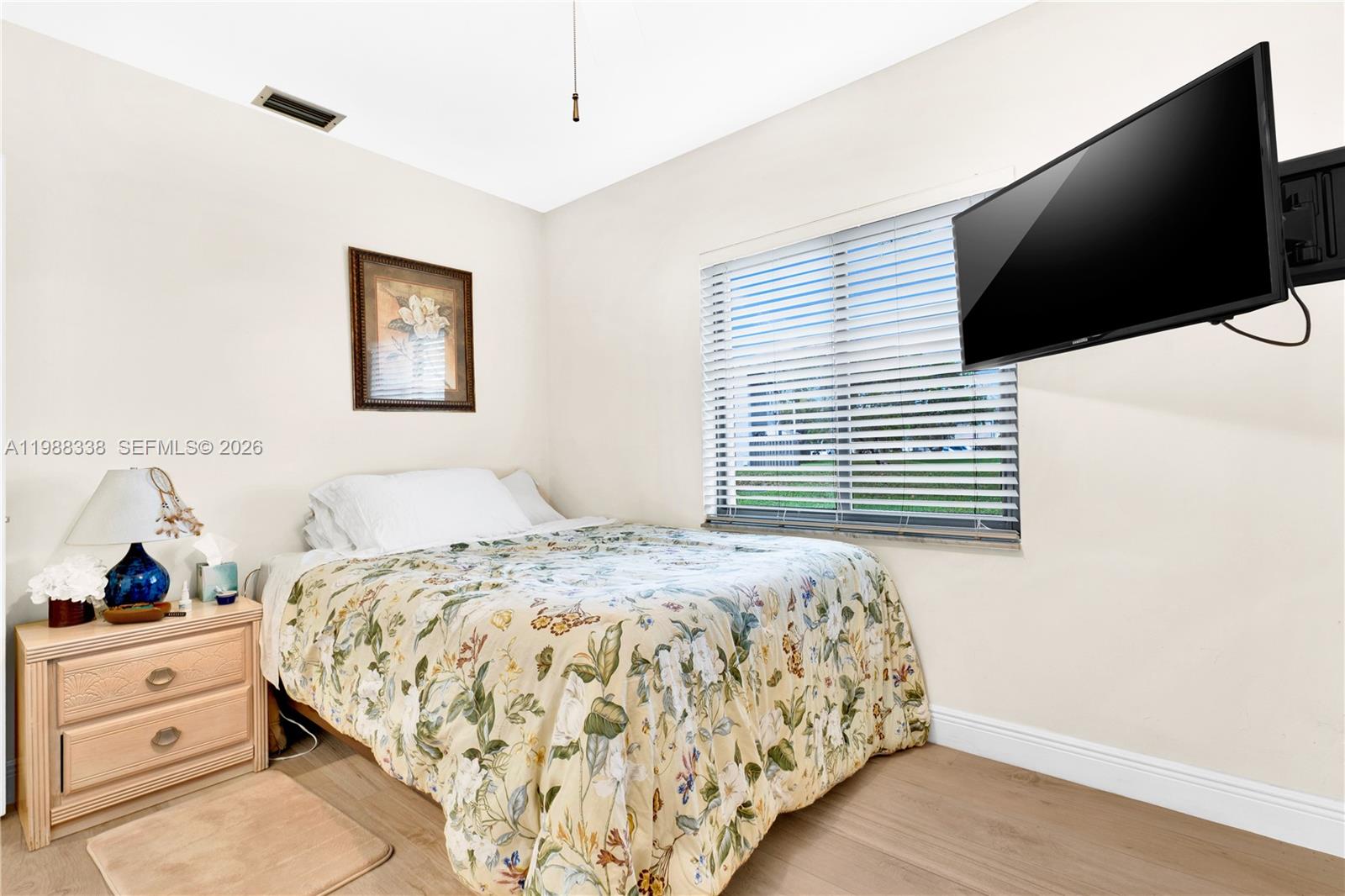 10909 Southwest 113th Place, Unit 68A Miami, FL 33176 - Photo 23 of 37 a bedroom with a bed and a flat screen tv