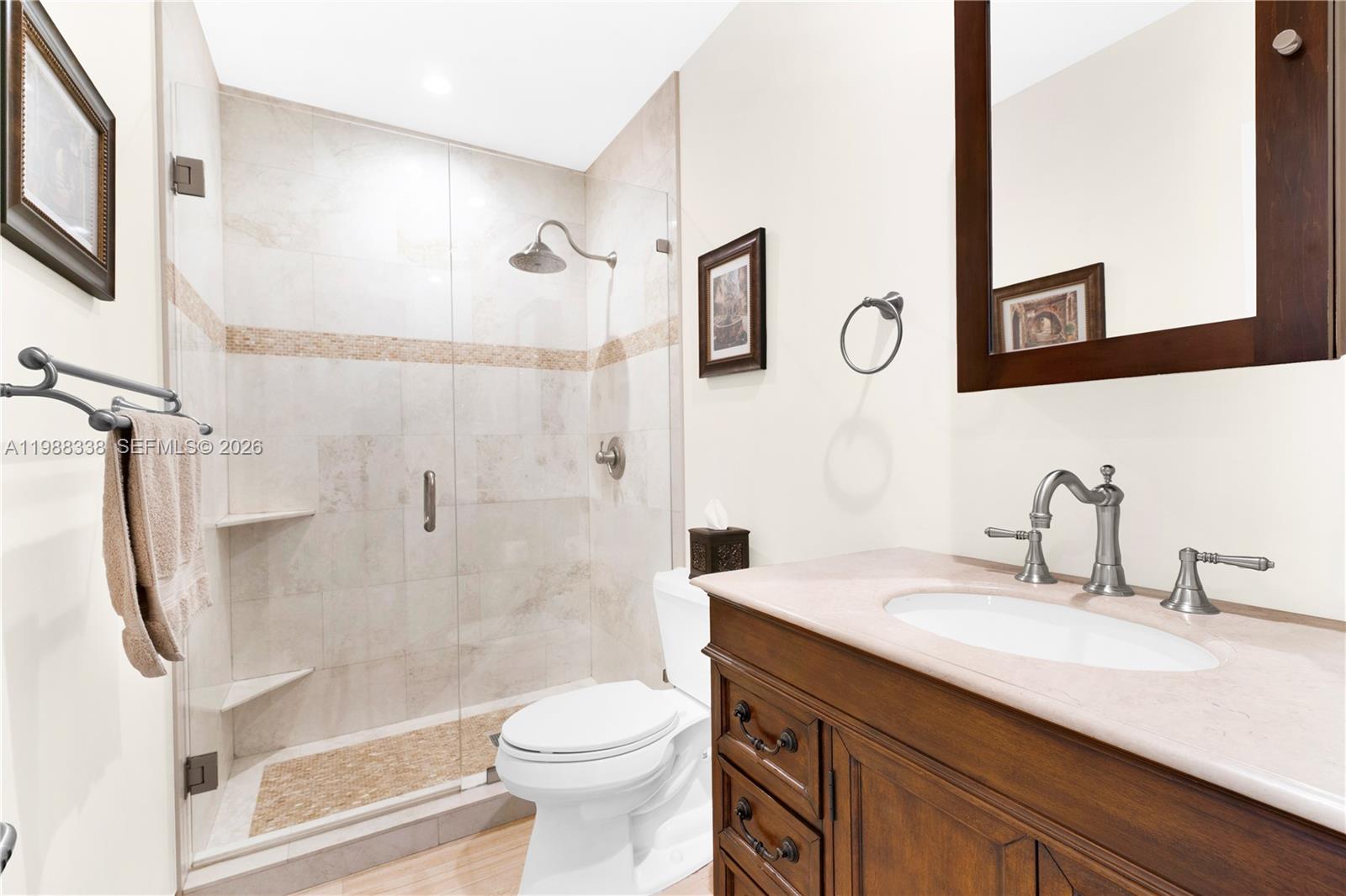 10909 Southwest 113th Place, Unit 68A Miami, FL 33176 - Photo 24 of 37 a bathroom with a granite countertop sink toilet and shower