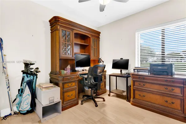 a view of workspace with wooden floor windows