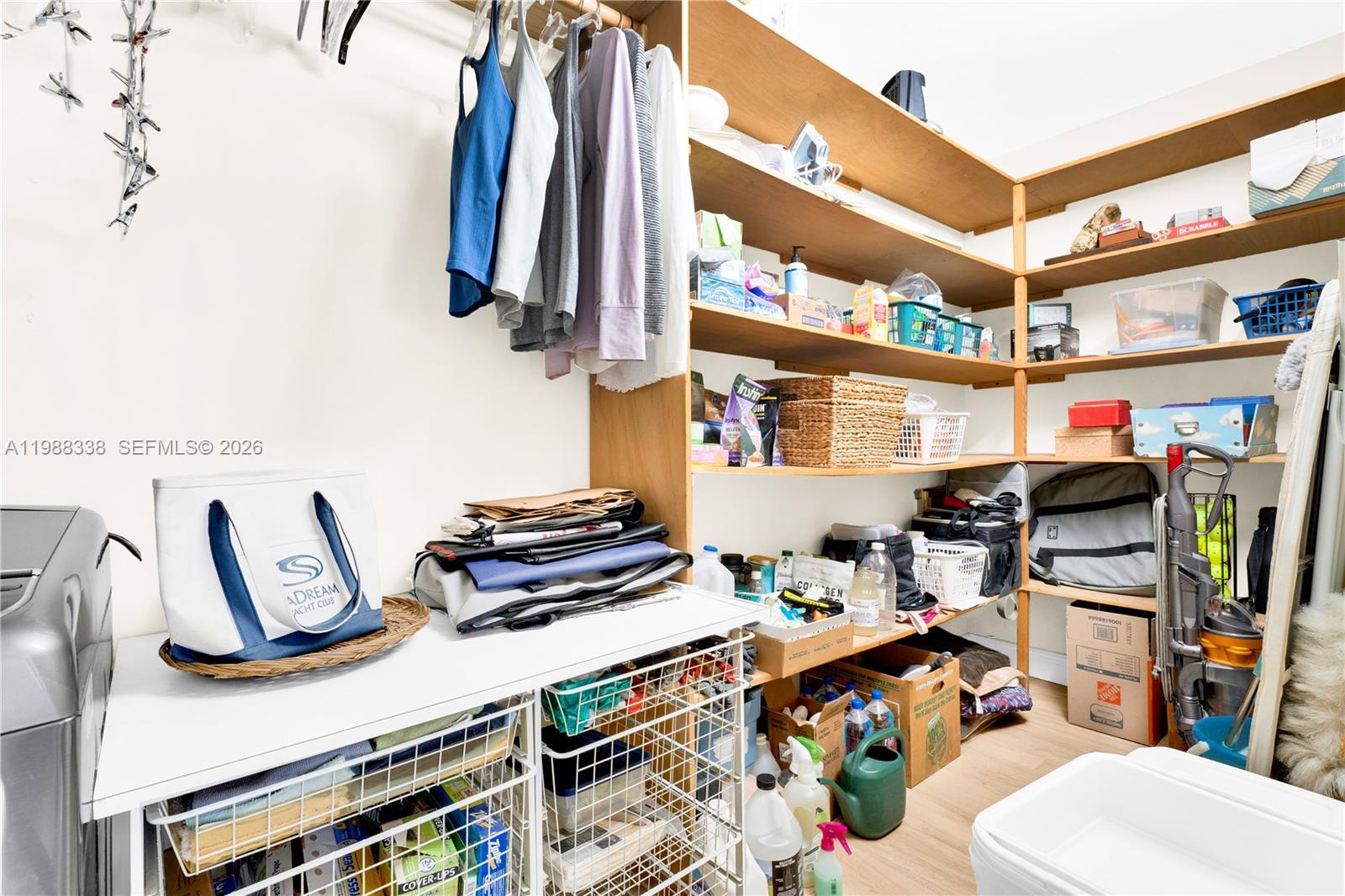 10909 Southwest 113th Place, Unit 68A Miami, FL 33176 - Photo 28 of 37 a view of walk in closet with clothes and shoes