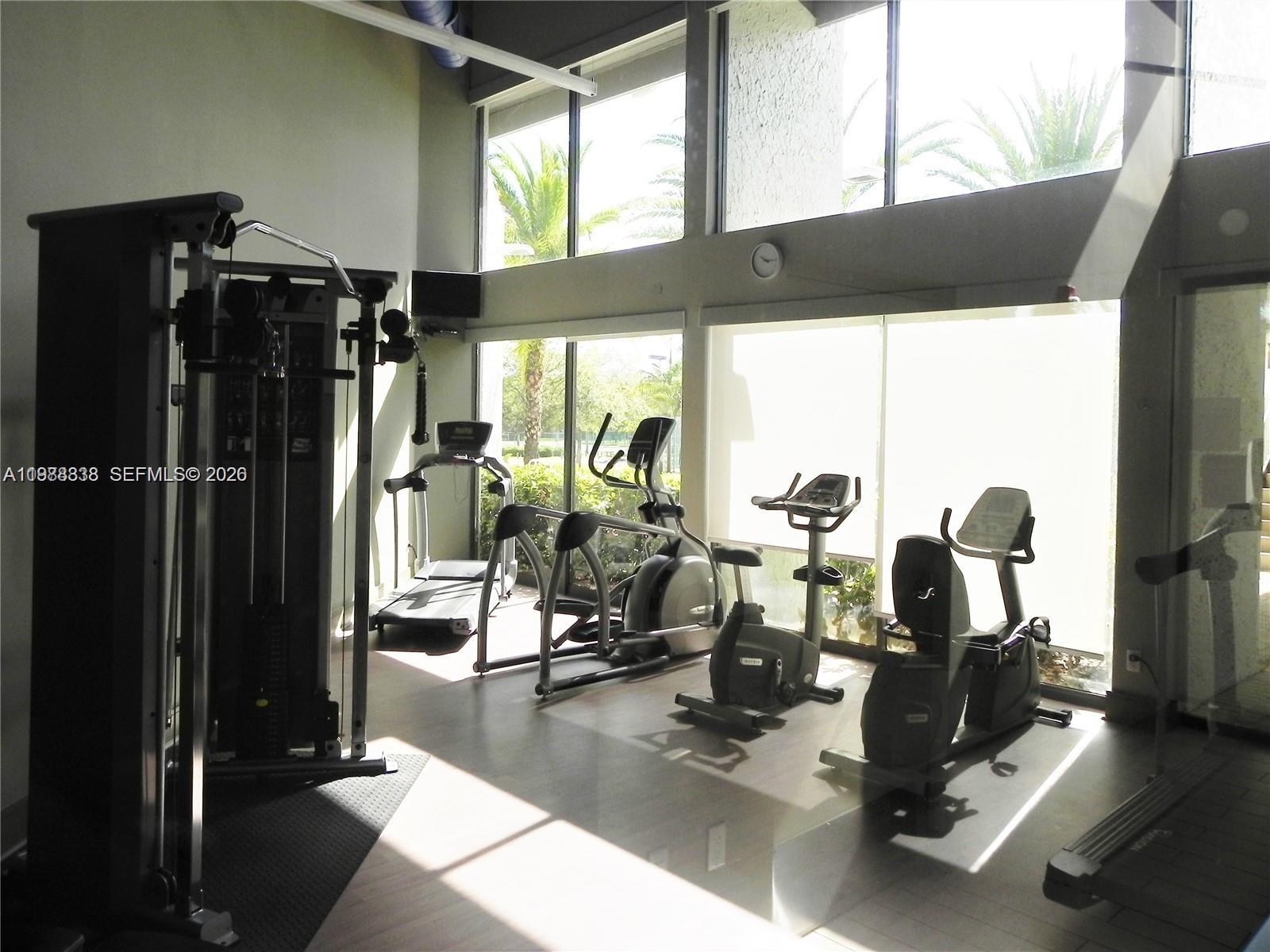 10909 Southwest 113th Place, Unit 68A Miami, FL 33176 - Photo 36 of 37 a view of a room with gym equipment
