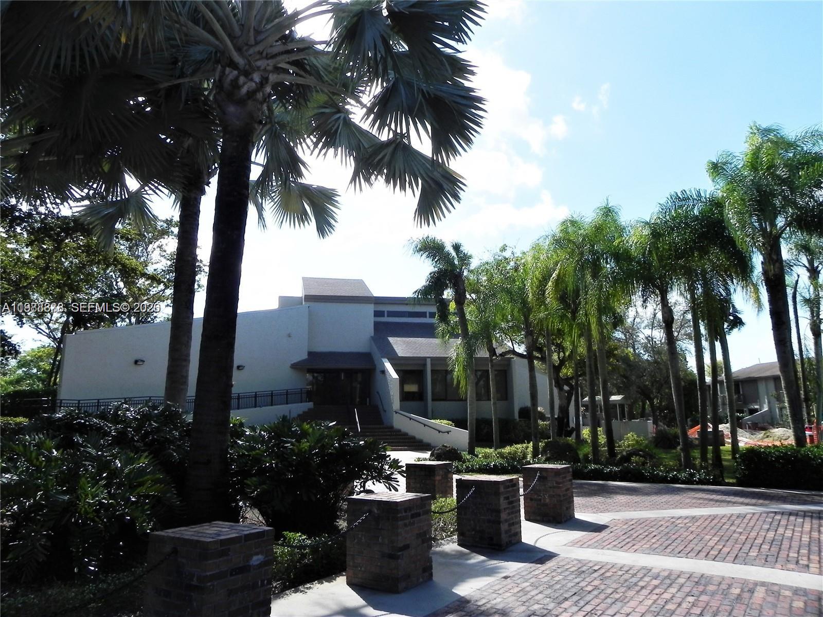 10909 Southwest 113th Place, Unit 68A Miami, FL 33176 - Photo 37 of 37 a view of a backyard with potted plants and palm trees