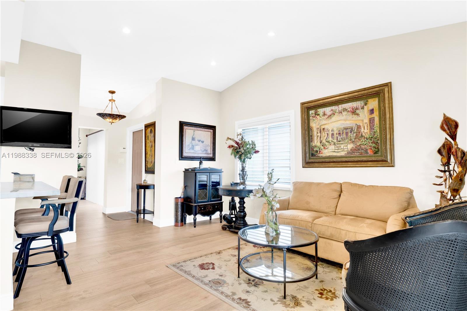 10909 Southwest 113th Place, Unit 68A Miami, FL 33176 - Photo 9 of 37 a living room with furniture and a flat screen tv