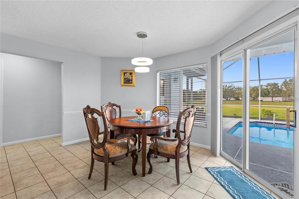 10446 Baylor Drive Spring Hill, FL 34608 - Photo 13 of 32 a view of a dining room with furniture window and outside view