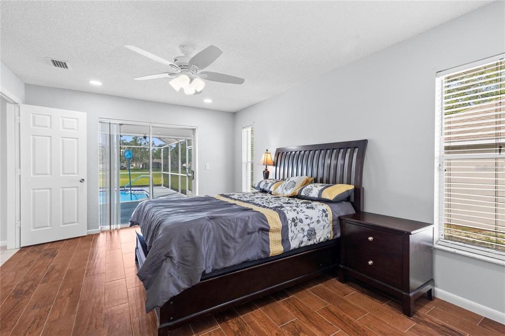 10446 Baylor Drive Spring Hill, FL 34608 - Photo 16 of 32 a bed sitting in a bedroom next to a window