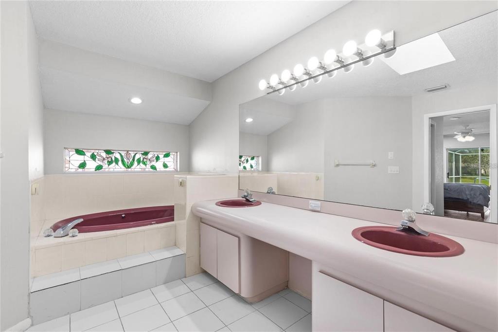 10446 Baylor Drive Spring Hill, FL 34608 - Photo 19 of 32 a bathroom with a sink and a mirror