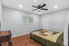 10446 Baylor Drive Spring Hill, FL 34608 - Photo 23 of 32 a bedroom with a bed and a table