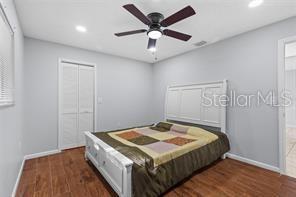 10446 Baylor Drive Spring Hill, FL 34608 - Photo 24 of 32 a bedroom with a bed and a ceiling fan