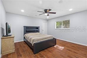 10446 Baylor Drive Spring Hill, FL 34608 - Photo 25 of 32 a bedroom with a bed and a window