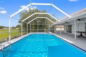 10446 Baylor Drive Spring Hill, FL 34608 - Photo 27 of 32 a view of a house with a swimming pool