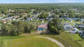10446 Baylor Drive Spring Hill, FL 34608 - Photo 31 of 32 an aerial view of residential houses with outdoor space and trees