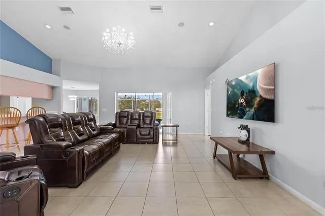 a living room with furniture and chandelier