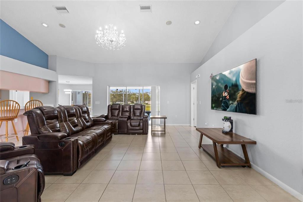 10446 Baylor Drive Spring Hill, FL 34608 - Photo 8 of 32 a living room with furniture and a flat screen tv