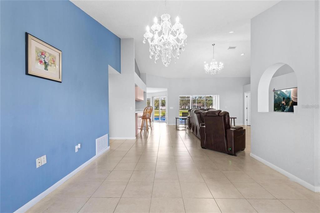 10446 Baylor Drive Spring Hill, FL 34608 - Photo 9 of 32 a living room with furniture and chandelier