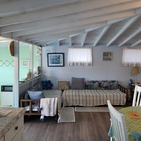 a living room with furniture and painting on the wall