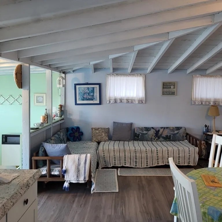 a living room with furniture and painting on the wall