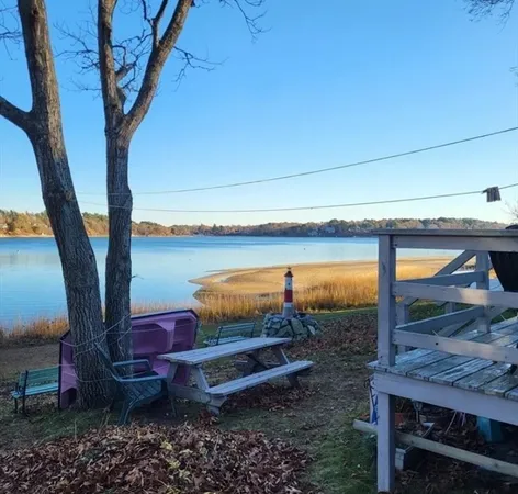 a view of a patio with wooden floor and floor to ceiling window
