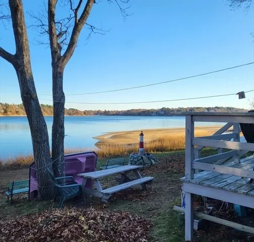 a view of a patio with wooden floor and floor to ceiling window