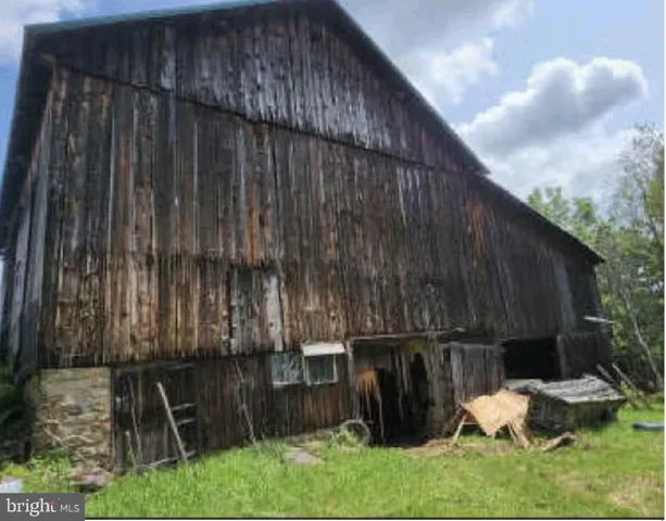 a backyard of a house with chairs and wooden fence