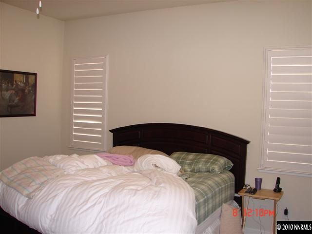 2608 Mule Circle Reno, NV 89521 - Photo 7 of 9 a bedroom with a bed and wooden floor