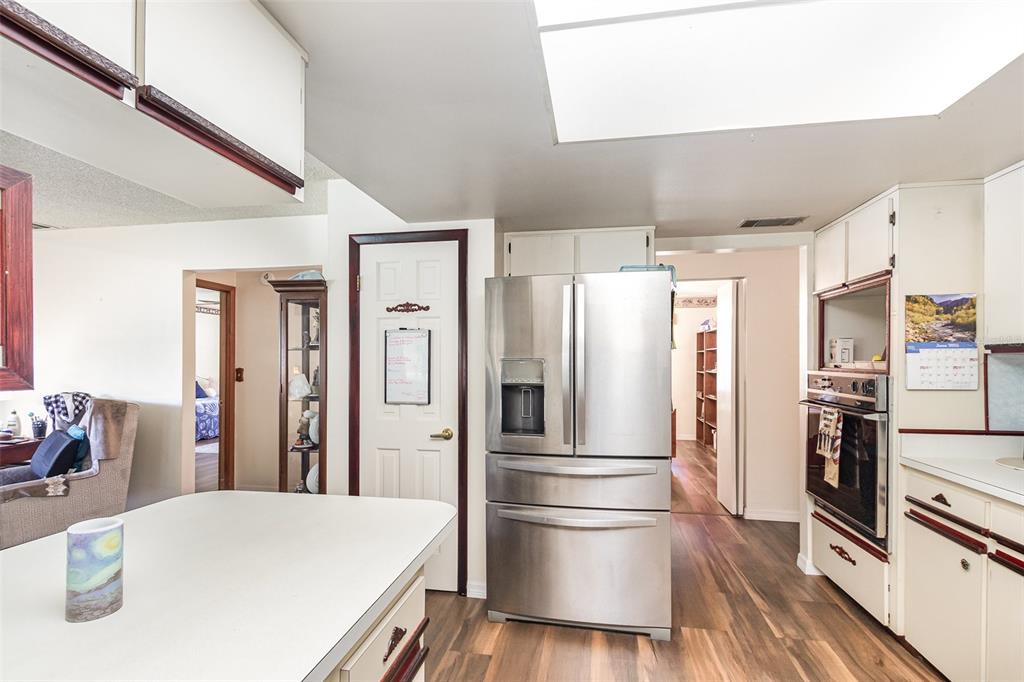 6476 Eve Street St. Cloud, FL 34771 - Photo 11 of 25 a kitchen with stainless steel appliances a refrigerator and a stove top oven
