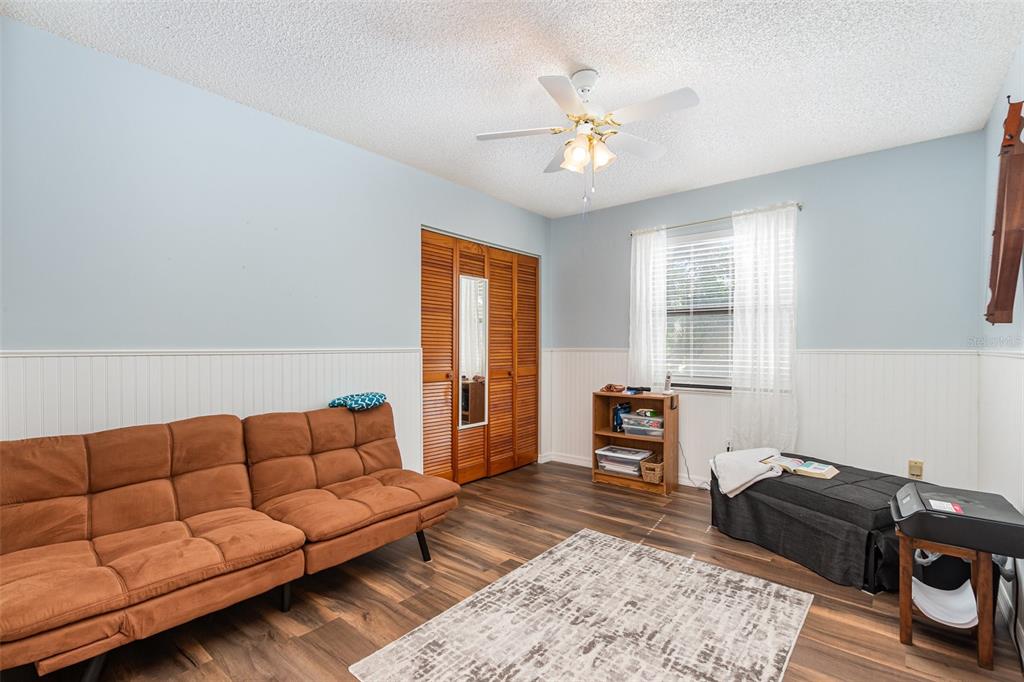 6476 Eve Street St. Cloud, FL 34771 - Photo 12 of 25 a living room with furniture and a flat screen tv