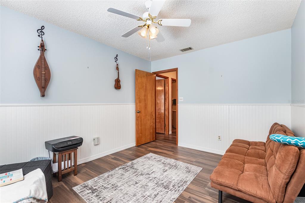 6476 Eve Street St. Cloud, FL 34771 - Photo 13 of 25 a living room with furniture and a rug