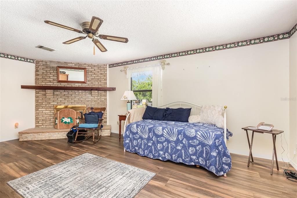 6476 Eve Street St. Cloud, FL 34771 - Photo 17 of 25 a living room with furniture and a fireplace