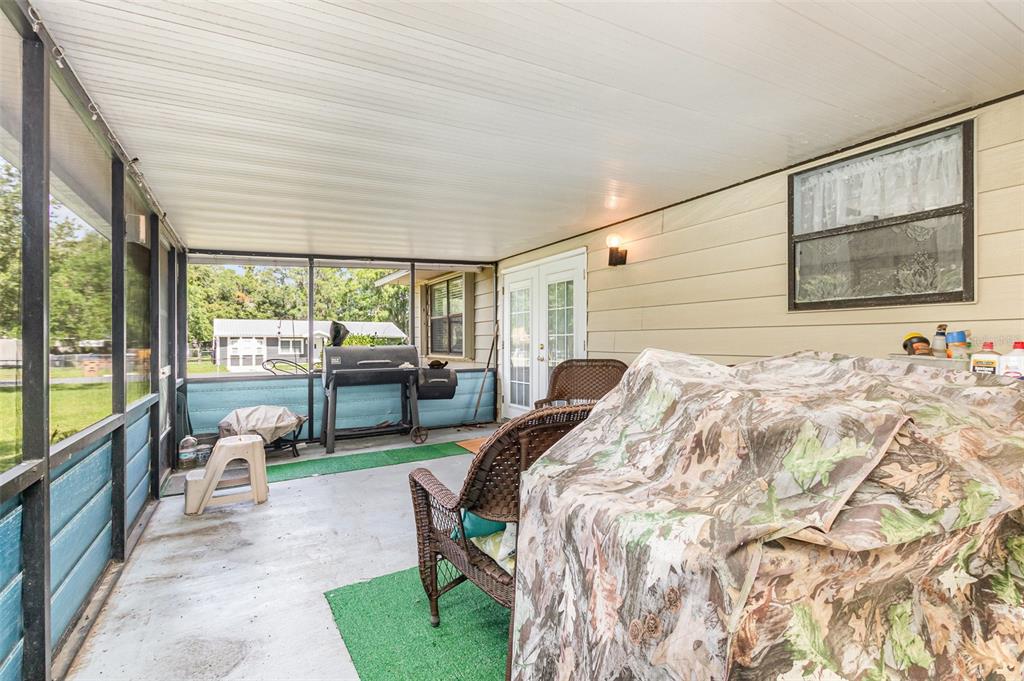 6476 Eve Street St. Cloud, FL 34771 - Photo 19 of 25 a bedroom with a bed and large windows